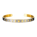 Spiritual Evolution Moon Phase Cuff featuring phases of the moon on a gunmetal background. This stylish spiritual jewelry piece symbolizes nourishment, protection, and the goddess, making it perfect for meditation, manifestation, and yoga practice.