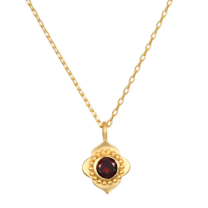 A close-up view of the Spiritual Strength Garnet Lotus Necklace featuring an intricately designed lotus pendant with a garnet stone. This elegant piece of spiritual jewelry serves as a talisman, embodying themes of meditation and meaningful manifestation, perfect for yoga and wellness enthusiasts seeking protection and grounding energy.