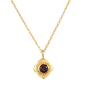 A close-up view of the Spiritual Strength Garnet Lotus Necklace featuring an intricately designed lotus pendant with a garnet stone. This elegant piece of spiritual jewelry serves as a talisman, embodying themes of meditation and meaningful manifestation, perfect for yoga and wellness enthusiasts seeking protection and grounding energy.