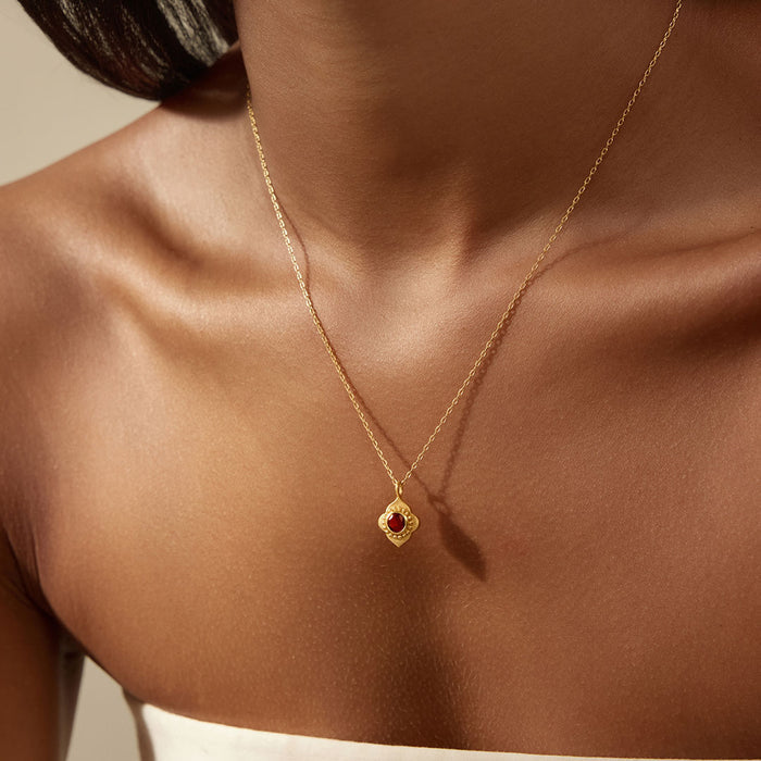 Spiritual Strength Garnet Lotus Necklace worn elegantly on a model's neck, showcasing its intricate lotus pendant and garnet accent, perfect for those seeking spiritual jewelry for meditation, protection, and meaningful manifestation.