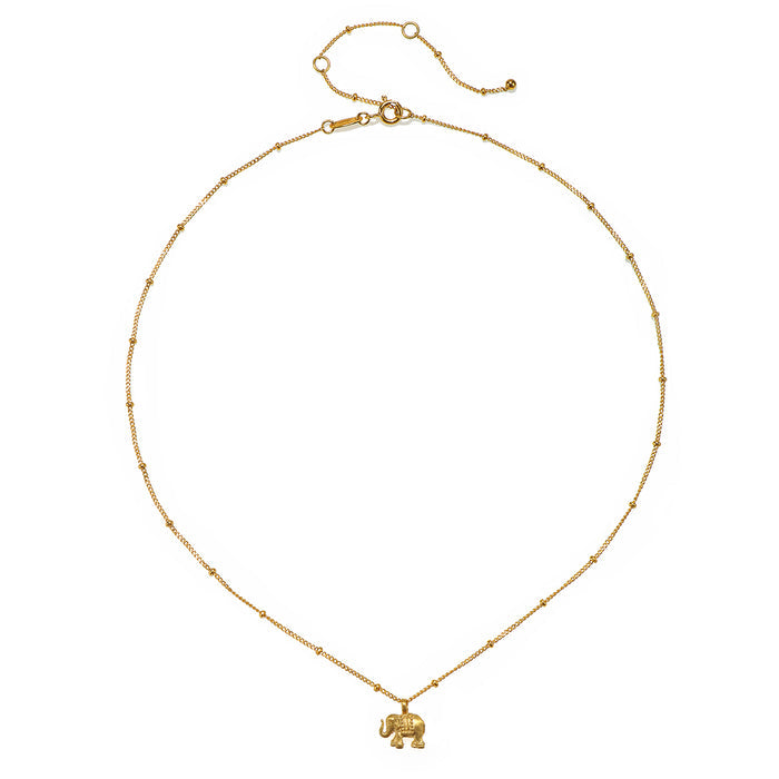 The Stand in Strength Elephant Necklace displayed in a flat lay format, highlighting its delicate gold beaded chain, making it a beautiful choice for protective and sacred spiritual jewelry.