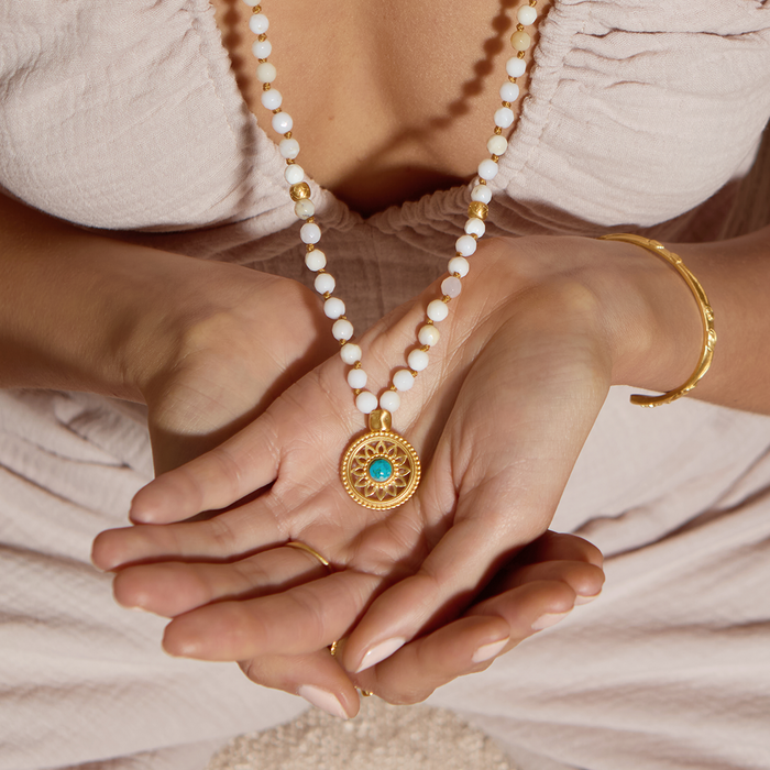 Close-up of the Step Into Self White Opal Mandala Mala held in hands, showcasing the intricate mandala pendant and white opal beads, a meaningful piece for spiritual practices, protection, and personal charm during meditation.