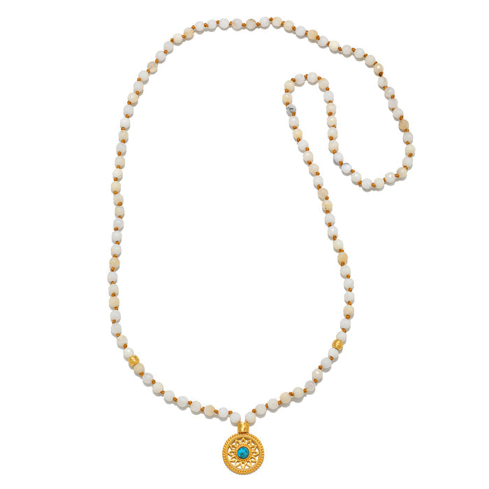 Flat lay of the Step Into Self White Opal Mandala Mala displayed neatly, emphasizing the 108 white opal and turquoise beads along with the mandala pendant, perfect for those seeking a connection to spiritual meaning and manifestation.