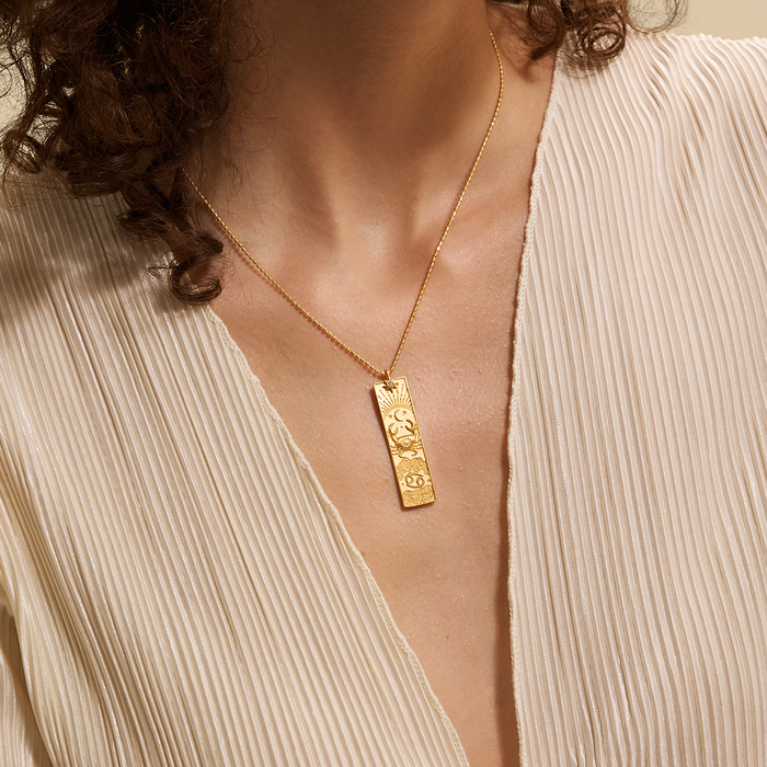 A model wearing the Story of Cancer Zodiac Necklace, highlighting its elegant design. This spiritual jewelry resonates with the energies of zodiac signs, promoting meditation and offering a meaningful symbol of protection, sun, moon, and spirituality.