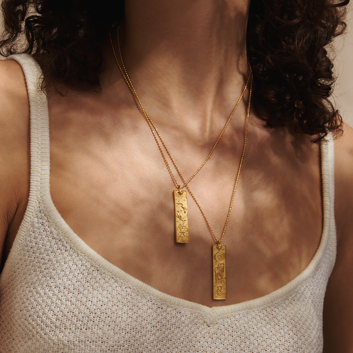 Layered view of the Story of Capricorn Zodiac Necklace styled with other spiritual jewelry, emphasizing its significance as a zodiac symbol for personal empowerment in yoga and meditation.