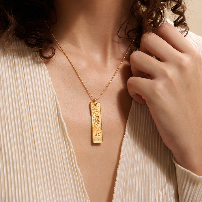 A model wearing the Story of Libra Zodiac Necklace, highlighting its beauty and connection to spirituality. This piece serves as a protection talisman for those interested in astrology, reinforcing intentions for manifestation and reflecting the essence of sun and moon energies.