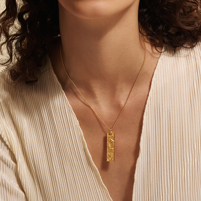 Close-up of the Story of Pisces Zodiac Necklace worn elegantly by a model. The intricate design highlights the zodiac symbol and the illuminating white topaz, making this spiritual jewelry a meaningful talisman for those aligned with the Pisces sign.
