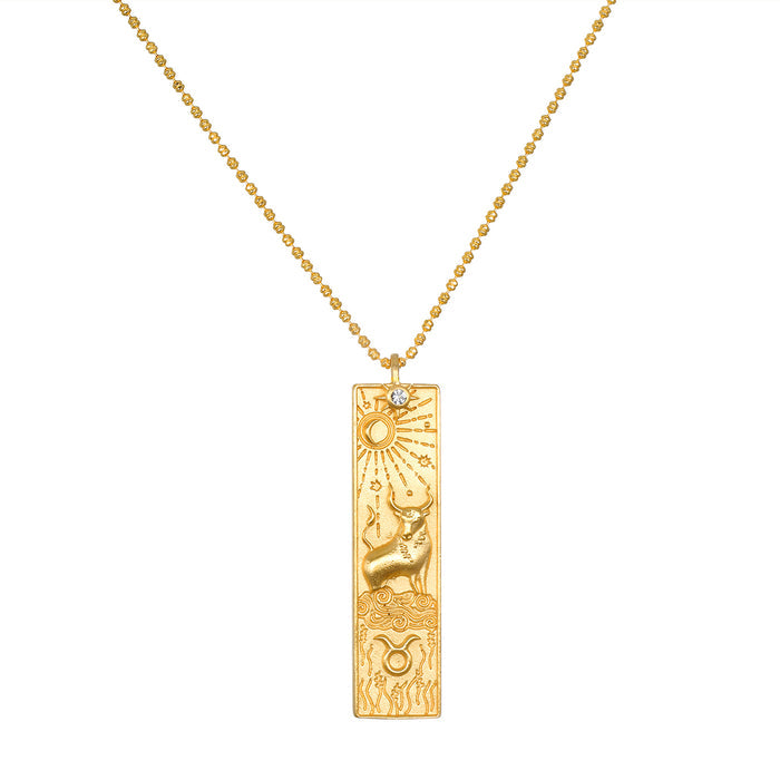 Story of Taurus Zodiac Necklace featuring an intricate gold pendant depicting the Taurus symbol along with celestial elements. This spiritual jewelry piece is perfect for meditation and serves as a talisman, connecting you with your zodiac sign. It embodies meaningful protection and manifestation energy, ideal for yoga practice.