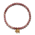 Rhodonite bead stretch bracelet with gold-tone elephant charm pendant.