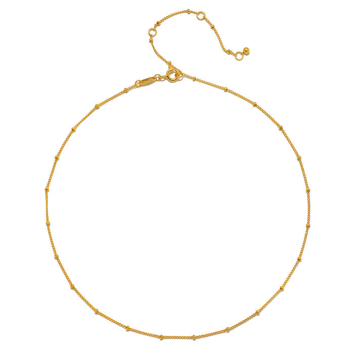 Image of Subtle Beauty Dot Chain Choker showcasing an elegant 18kt gold plated chain adorned with delicate golden dots, perfect for layering. This spiritual jewelry piece resonates with themes of meditation, talisman, and protection, symbolizing the sun and moon, ideal for yoga enthusiasts seeking meaningful manifestations.