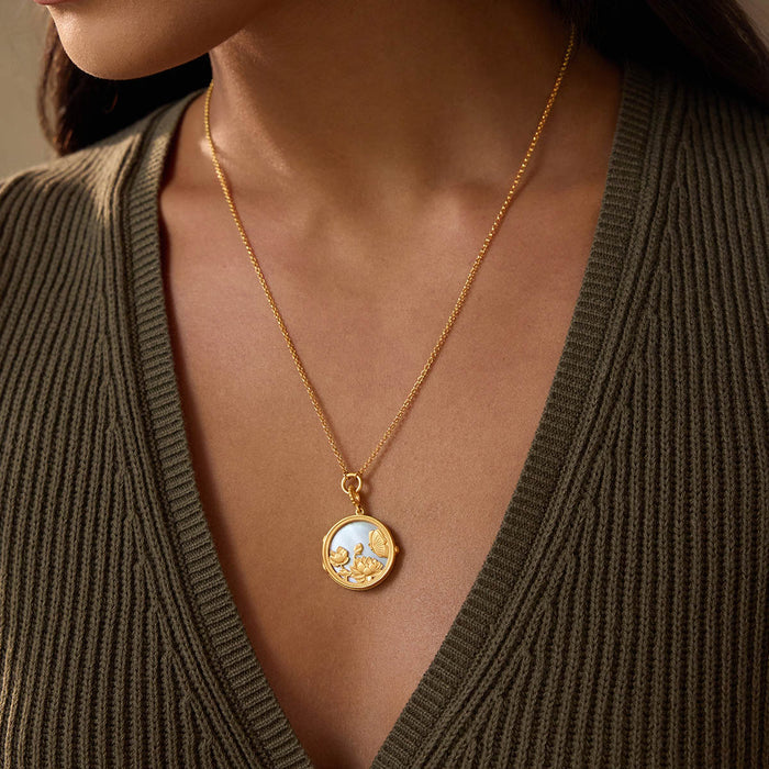 The Take Flight Butterfly Pearl Locket Necklace elegantly displayed on a model, symbolizing transformation and new beginnings. This piece of spiritual jewelry is perfect for meditation and serves as a meaningful talisman for protection and manifestation.