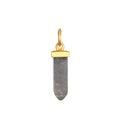 Gray stone bullet-shaped pendant with gold-tone metal cap and loop attachment.