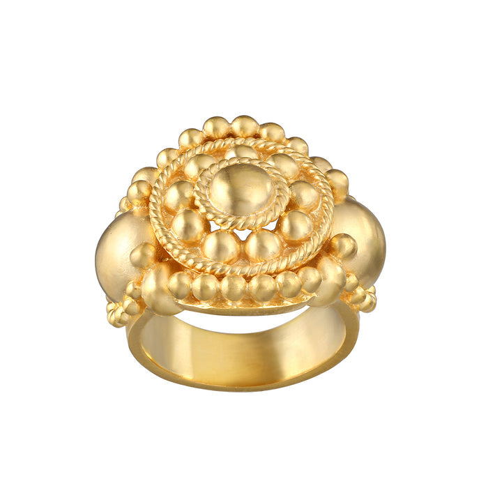 Gold ring with mandala design featuring concentric circles of spheres and twisted rope detailing on wide band.