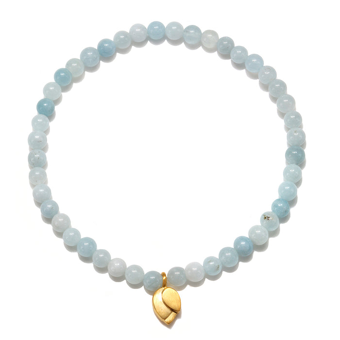Tranquil Journey Lotus Aquamarine Gemstone Bracelet showcasing smooth aquamarine beads and a gold plated lotus flower charm, perfect for spiritual jewelry, meditation gifts, and yoga practices. This meaningful piece symbolizes tranquility, courage, and new beginnings, embodying protective and sacred qualities for manifestation and personal growth.