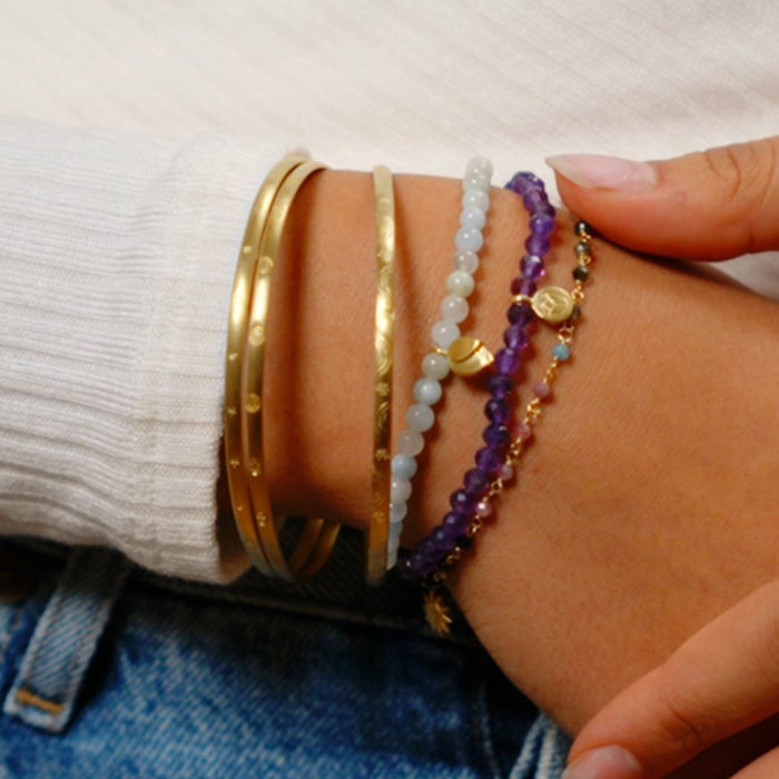 Tranquil Journey Lotus Aquamarine Gemstone Bracelet showcased alongside other spiritual jewelry, ideal as meditation gifts for yoga practitioners. This meaningful piece symbolizes tranquility and courage, offering protective qualities, making it a perfect amulet for manifestation and sacred intentions.