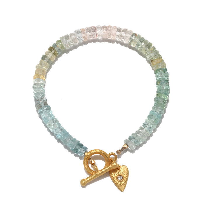 Tranquil Spirit Aquamarine Heart Toggle Bracelet displayed elegantly, showcasing unique aquamarine stones. This piece of spiritual jewelry serves as a meditation talisman, embodying the meaning of protection and peace, perfect for aligning with zodiac energies and enhancing yoga practices.