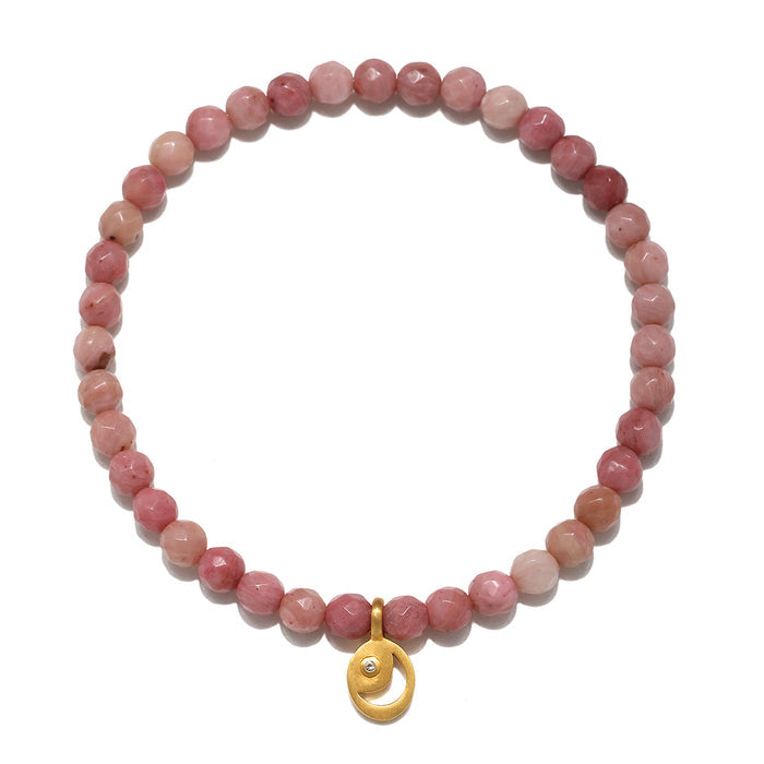 Stretch bracelet with pink rhodonite beads and gold-toned moon-shaped charm pendant.