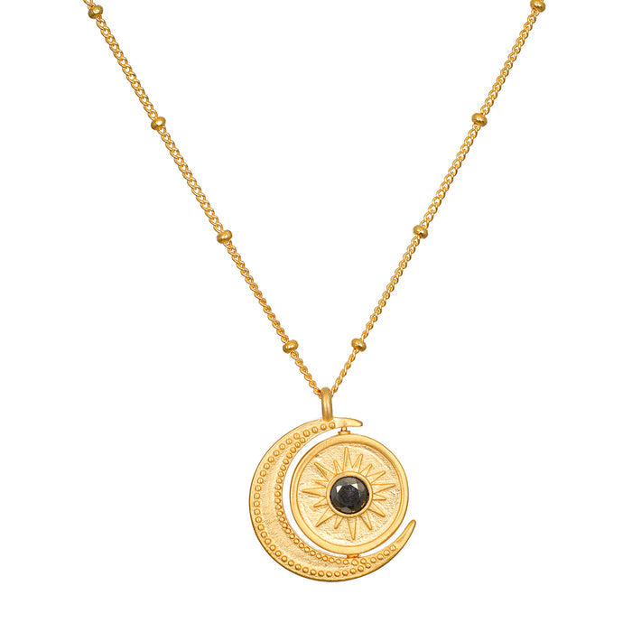 Detailed view of the United in Light Spinning Pendant Necklace featuring the sun and moon design, crafted from 18kt gold plating. This meaningful talisman is an exceptional piece of spiritual jewelry, perfect for manifestation, meditation, and enhancing one's connection to the zodiac and yoga.
