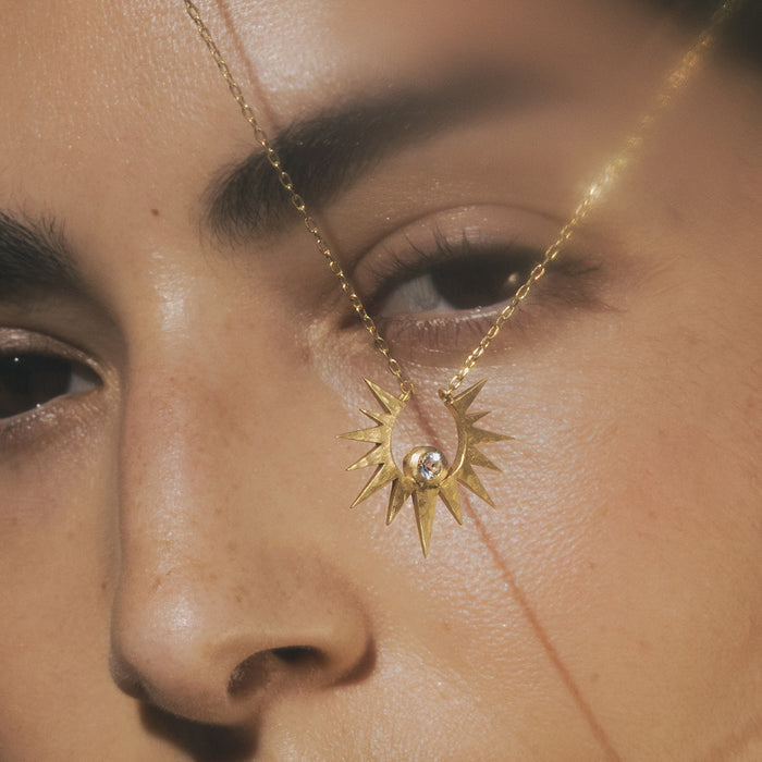 Close-up of the Unveiling Dreams White Topaz Starburst Necklace on a model, highlighting its intricate design and white topaz stone, representing spiritual connection and meaningful protection in meditation and yoga.