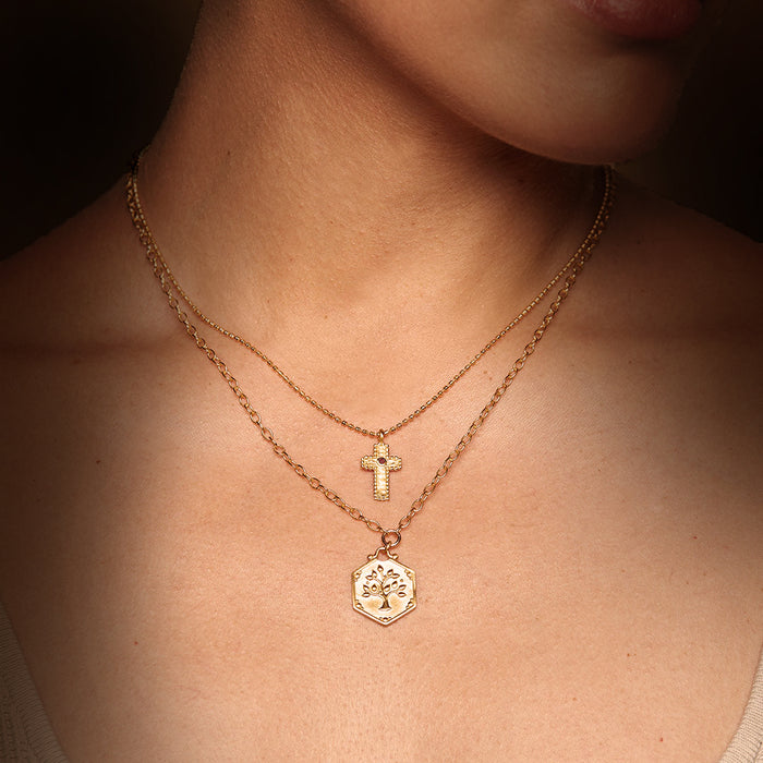Layered Unwavering Faith Garnet Cross Necklace showcasing a delicate cross and a meaningful pendant, ideal for those seeking spiritual jewelry that resonates with zodiac signs and talismans for positivity and guidance.