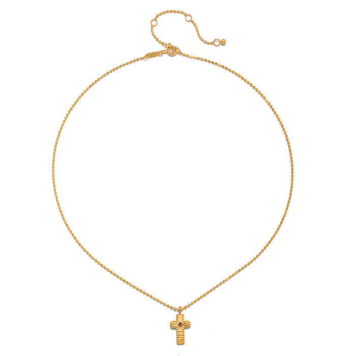 Close-up of the Unwavering Faith Garnet Cross Necklace highlighting its intricate design and 18kt gold plating, representing a meaningful piece for meditation and spiritual protection, making it a perfect addition to yoga and wellness practices.
