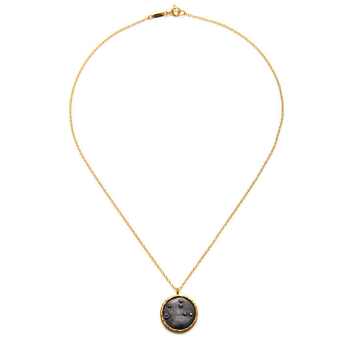 Virgo Zodiac Necklace displayed with a simple yet elegant design, featuring a black pendant on a gold chain, a symbolic piece for manifestation and meditation, and a thoughtful addition to spiritual jewelry collections.
