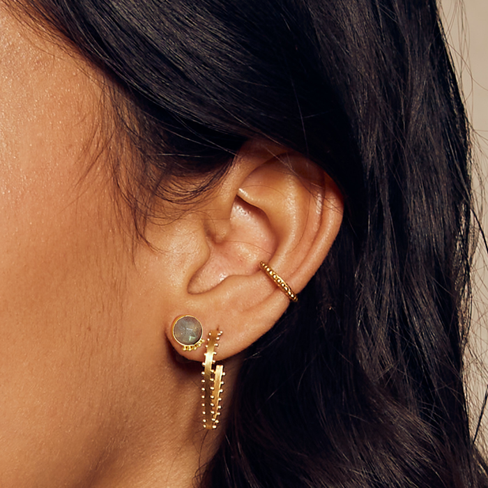 Close-up of the Vital Energy Ear Cuff paired with other jewelry pieces, blending sun and moon elements, ideal for those seeking spiritual and meaningful adornments.
