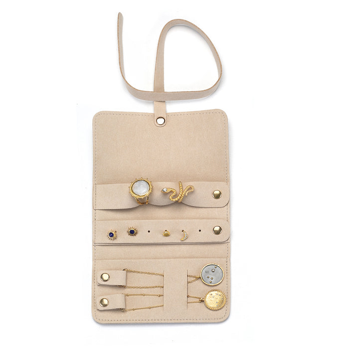 Interior view of the Weekend Journey Travel Jewelry Wrap Holder Tan, showcasing compartments for rings, earrings, and necklaces. This travel wrap is tailored for those who cherish their spiritual jewelry, including malas and zodiac talismans, enhancing your journey of manifestation and protection.