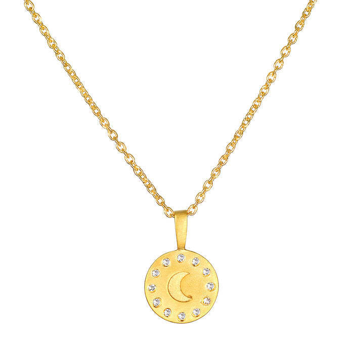 Gold chain necklace with round pendant featuring crescent moon and white crystal stones arranged in a circle.