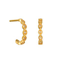 Pair of gold hoop earrings with white crystal stones set in diamond-shaped patterns along the curved surface.