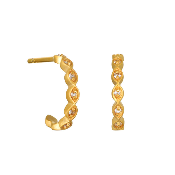 Pair of gold hoop earrings with white crystal stones set in diamond-shaped patterns along the curved surface.
