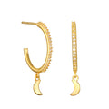 Gold-tone hoop earrings with crystal embellishments and crescent moon charm pendants.