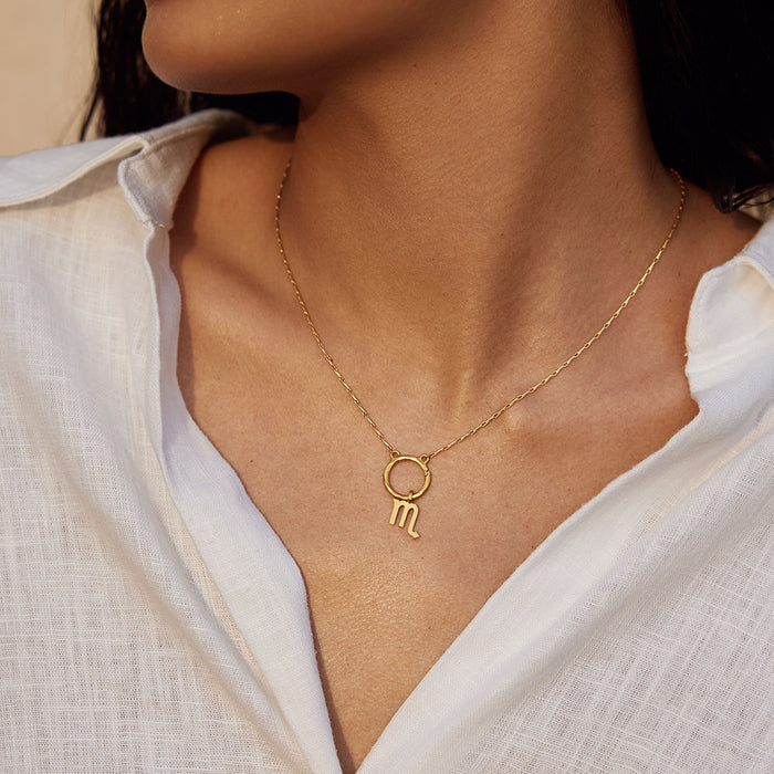 Detailed view of a Zodiac Glyph Charm necklace with the Scorpio symbol, representing spirituality and personal protection. This meaningful piece of spiritual jewelry enhances meditation and yoga practices.